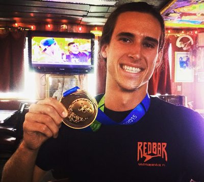 Adam Pickos, who also works at the Red Bar, poses with his gold medal after the 2015 Pan Am Games.