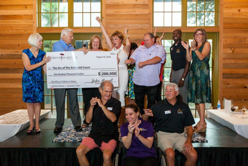 The Destin Charity Wine Auction Foundation surprised The Arc of the Emerald Coast with a $200,000 check at a ceremony on Tuesday. Photo by STM Photography.