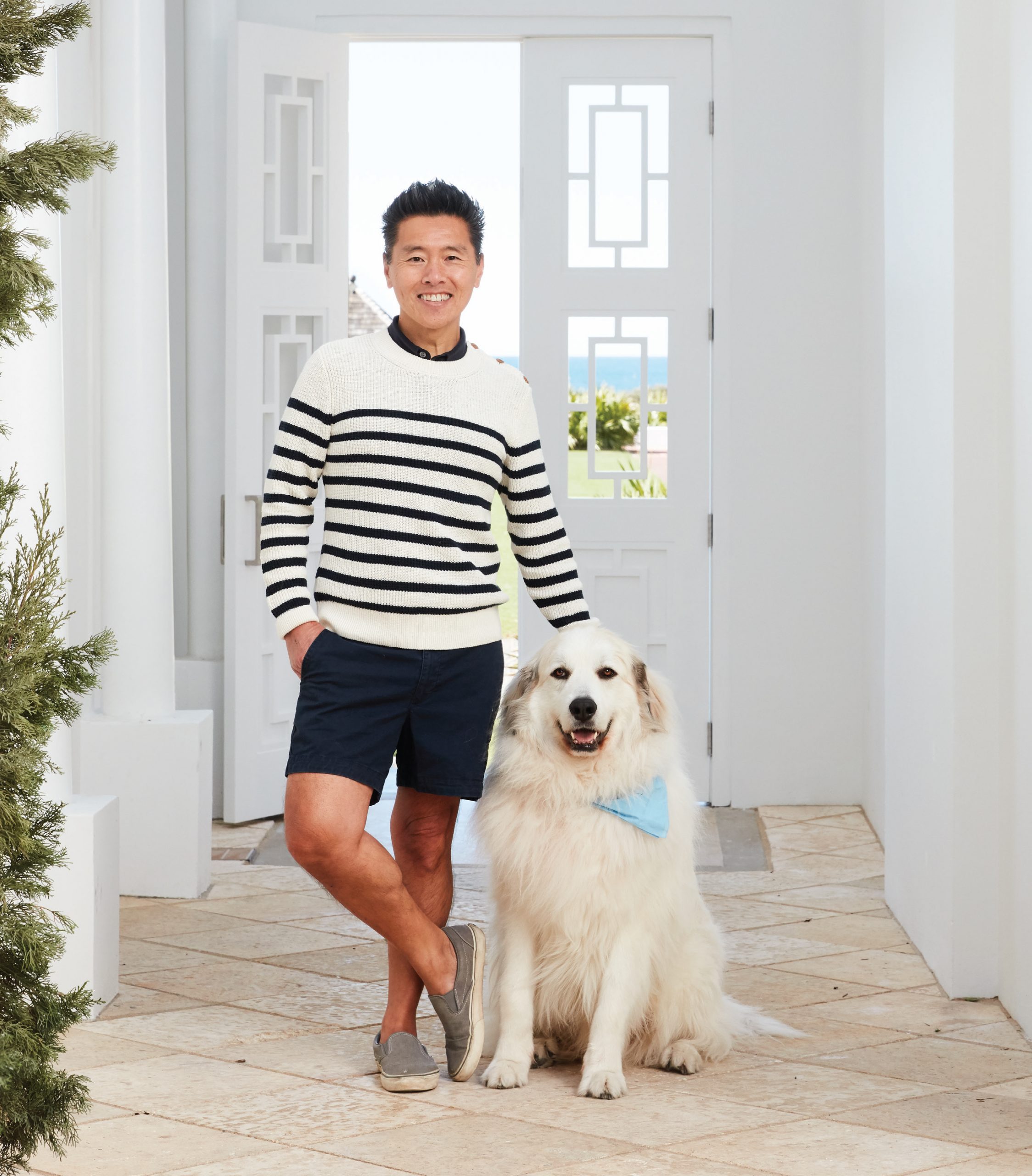 Yip poses in doorway with dog