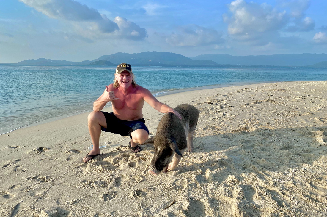 Mike Ragsdale poses with pig on beach