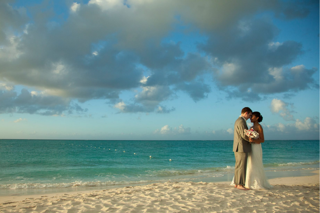 Wedding couple poses on beach