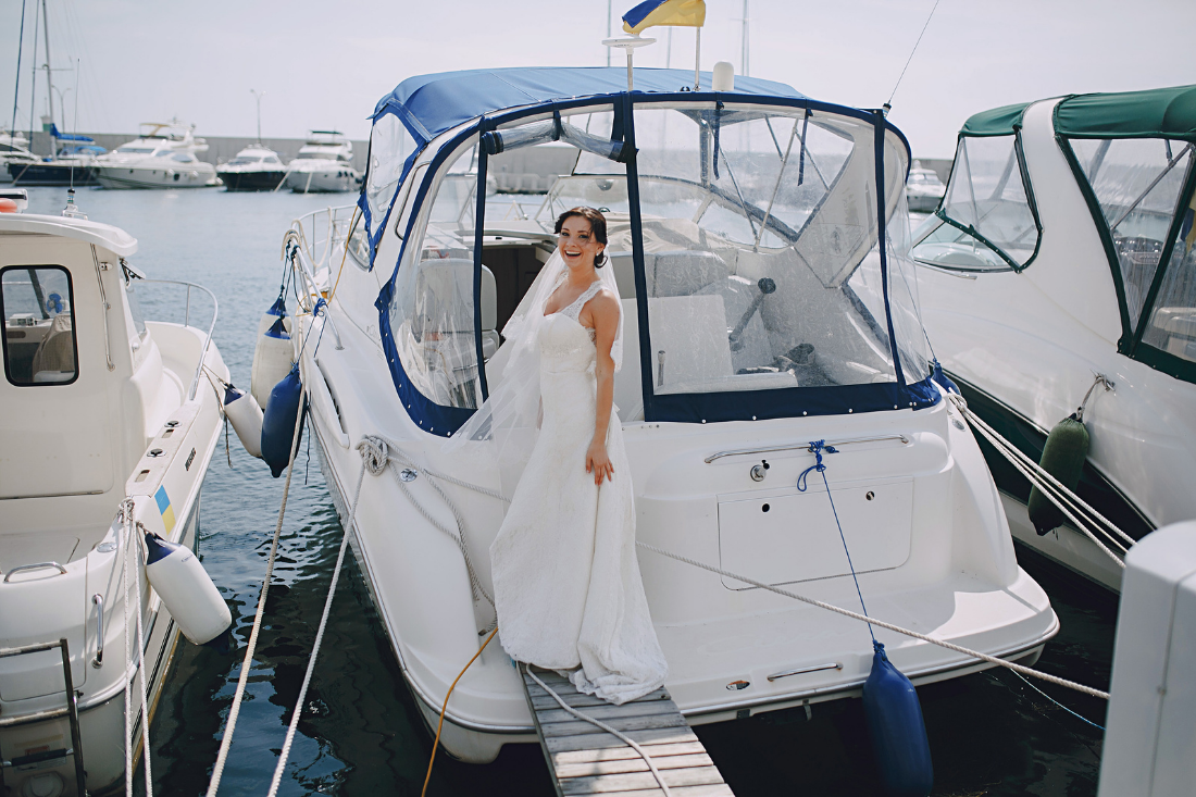 Bride smiles on back of boat