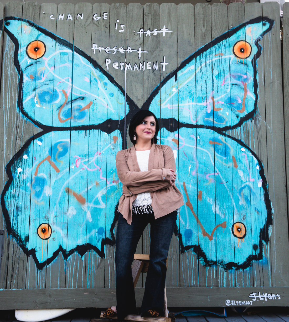 Ragan posing in front of butterfly mural in 30A