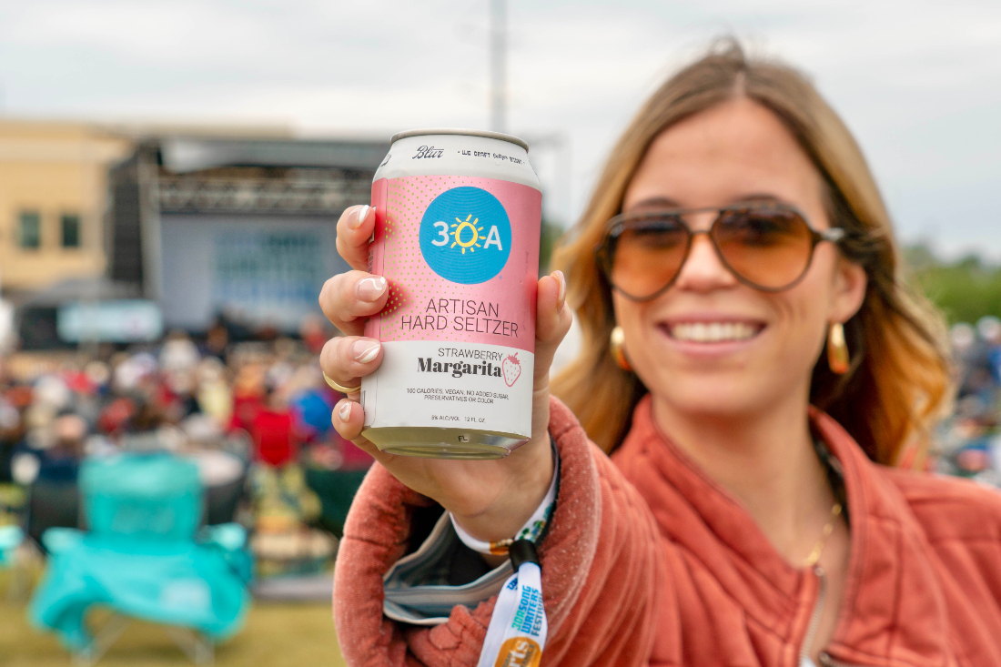 Girl holding 30A Hard Seltzer at event